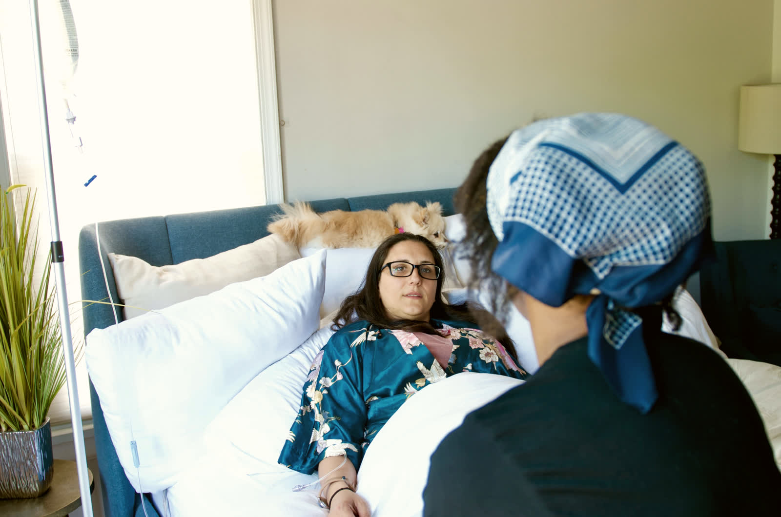 A nurse checking on a client during an infusion at home